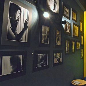 Black and white photography exhibition by Christiana Kokore displayed on the walls of Cinque Wine & Deli Athens.