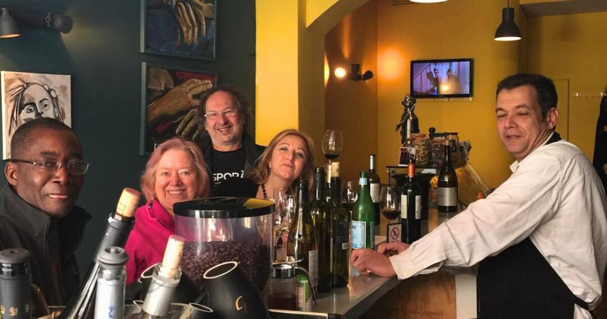 International wine lovers with Cinque team at wine bar in Psyrri Athens enjoying Greek bottled wines.