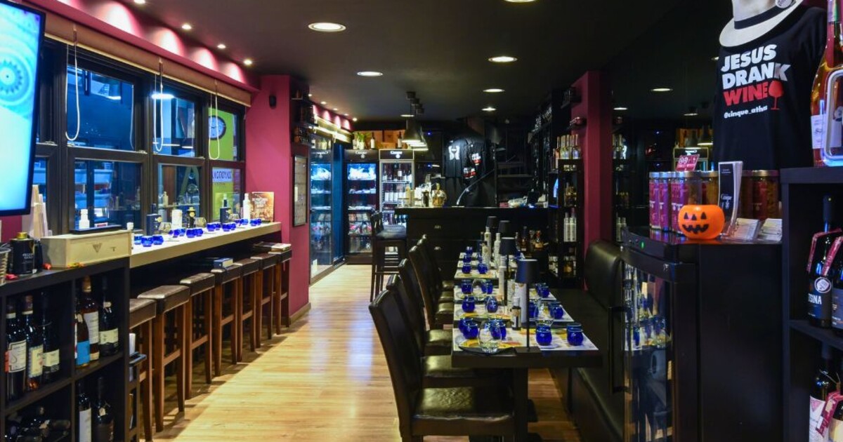 Interior of Cinque Wine & Deli Monastiraki, showcasing the modern wine bar layout, tasting tables and curated Greek wine selection in Athens.
