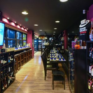 Interior of Cinque Wine & Deli Monastiraki, showcasing the modern wine bar layout, tasting tables and curated Greek wine selection in Athens.