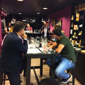 Riedel Masterclass wine tasting session at Cinque Wine & Deli Athens with participants seated around tasting table using Riedel glasses.