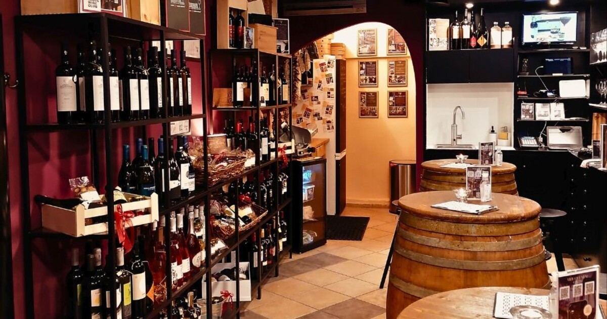 Cinque maroussi interior with wine shelves and barrel tables reflecting everyday urban wine culture in Athens
