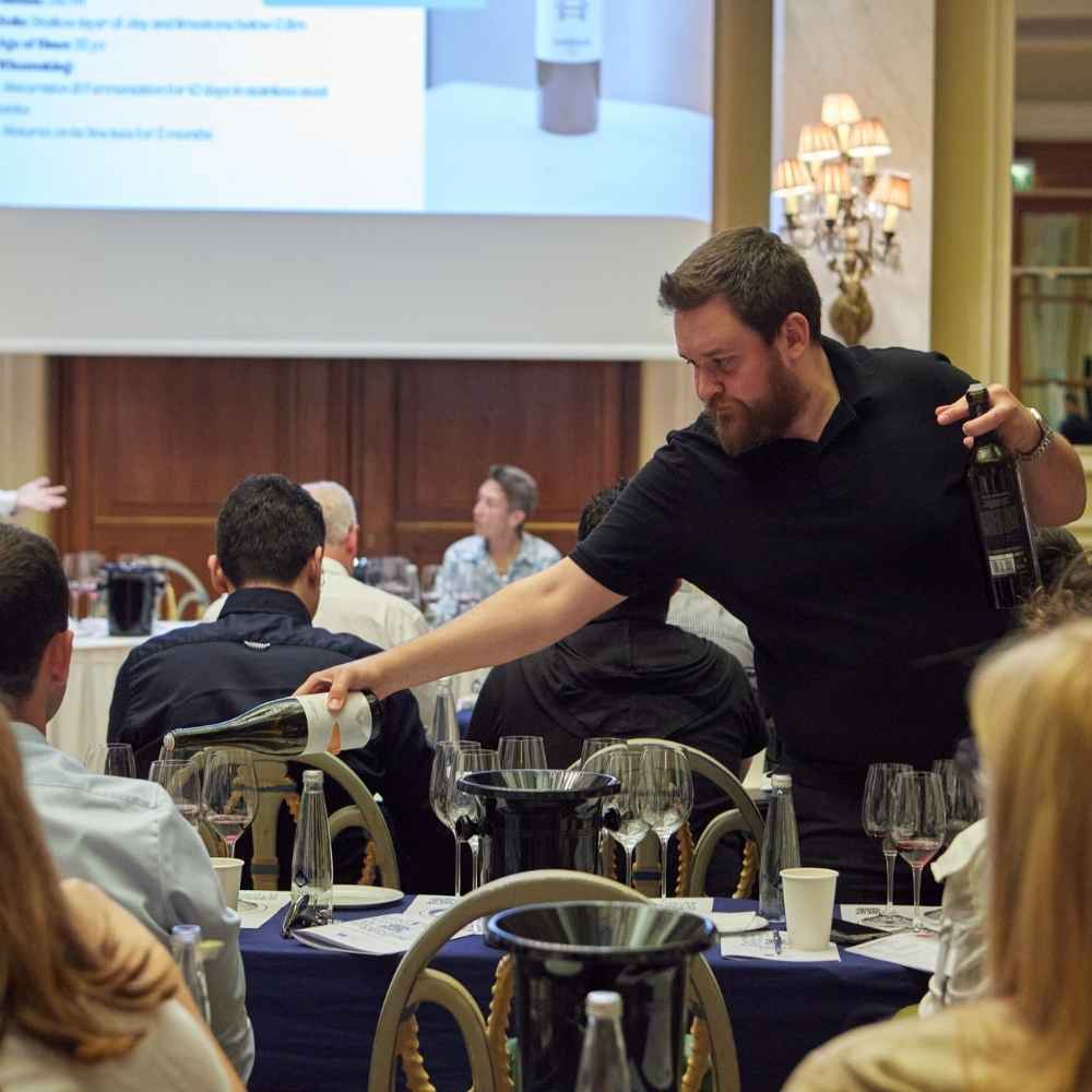 Wine tasting presentation during Great Greek Wines 2025 event, showcasing professional wine service and Greek wine expertise.