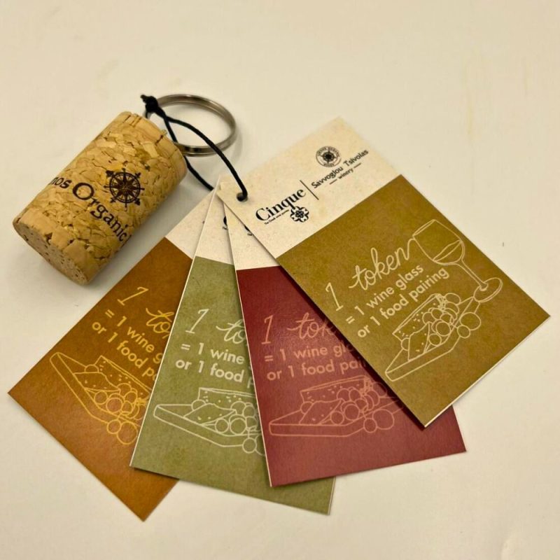Cinque tasting tokens used for wine glasses and food pairings during the Taste Limnos wine tasting event.