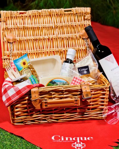 A premium picnic basket filled with Greek wines, cheeses, olive oil, and artisanal treats—available for takeaway exclusively from Cinque Monastiraki.