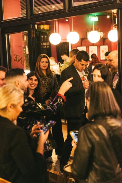 Guests participating in a guided wine tasting experience at a Cinque Wine & Deli location.
