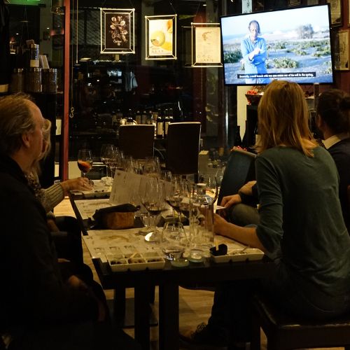 Guests attending a sommelier-led wine tasting at Cinque Signature flagship wine bar.