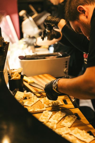 Cinque Wine & Deli team preparing cheese and deli products during daily service operations.