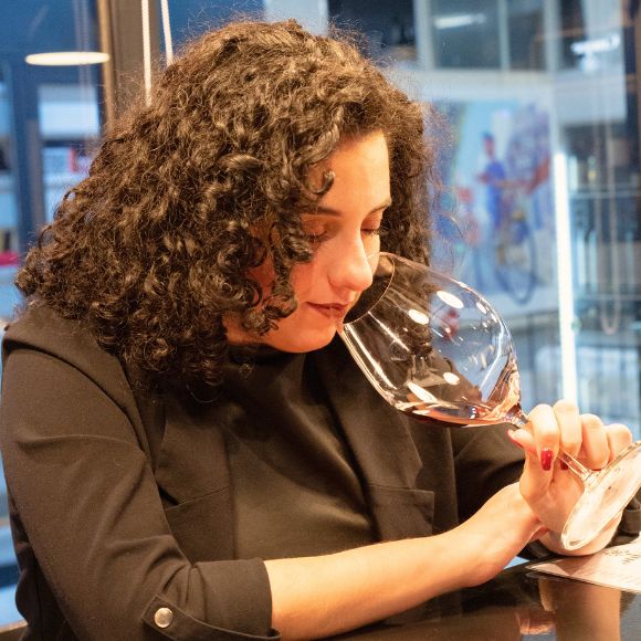 Sommelier evaluating wine aromas during a tasting session at Cinque