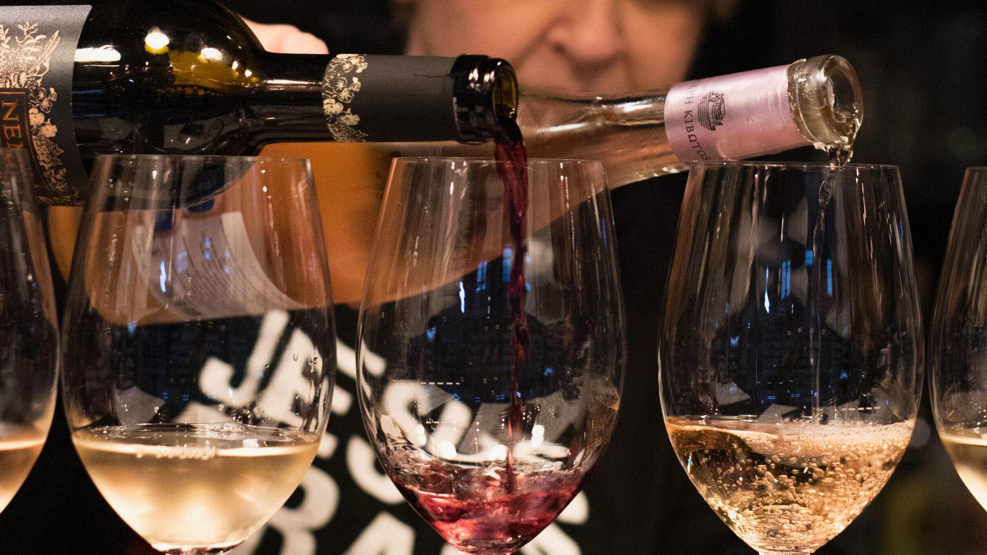 Guided Greek wine tasting with multiple wine flights being poured into glasses at Cinque Wine & Deli