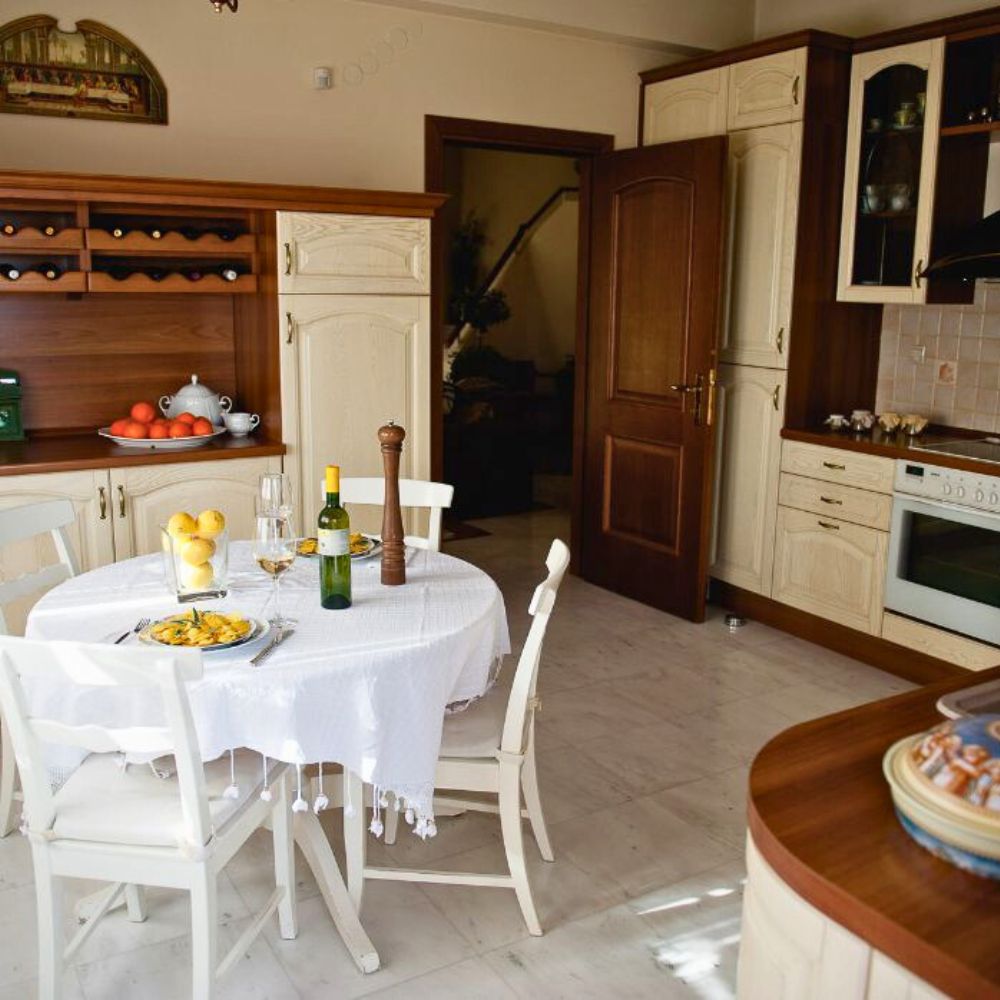 Traditional Greek kitchen and dining table at Casa Cinque in Lamia, hosting a hands-on Greek cooking experience
