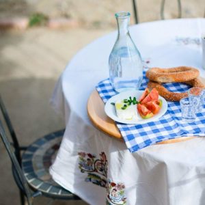 Breakfast table at Casa Cinque with local Greek food and simple setting, reflecting home-style hospitality and slow living within the Cinque Network.