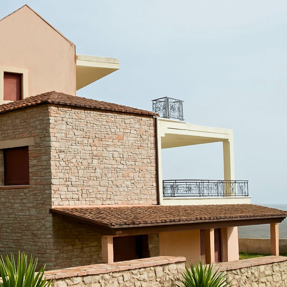 Exterior view of Casa Cinque, a stone-built house designed as a home-style hospitality experience within the Cinque Network in Lamia, Greece.