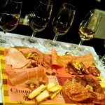Greek wine and charcuterie tasting with assorted cured meats and wine glasses at Cinque Wine & Deli
