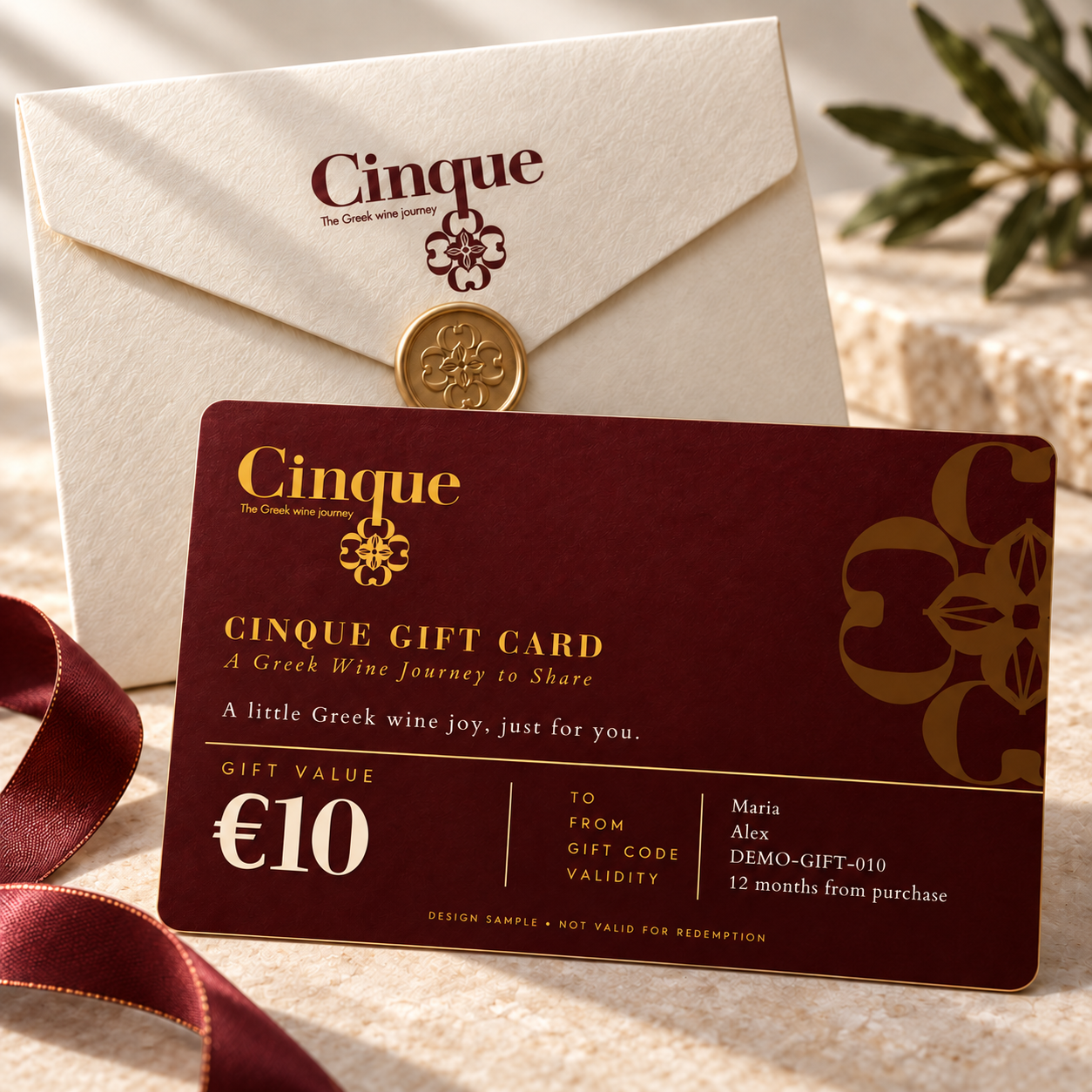 Cinque €10 digital gift card in burgundy and gold, displayed with an ivory envelope.