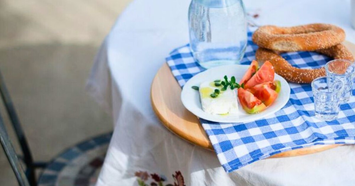 Breakfast table at Casa Cinque with local Greek food and simple setting, reflecting home-style hospitality and slow living within the Cinque Network.