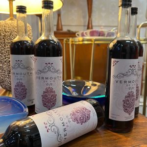 Cinque Vermouth bottles displayed at Cinque Wine & Deli highlighting Greek botanicals and wine-based vermouth