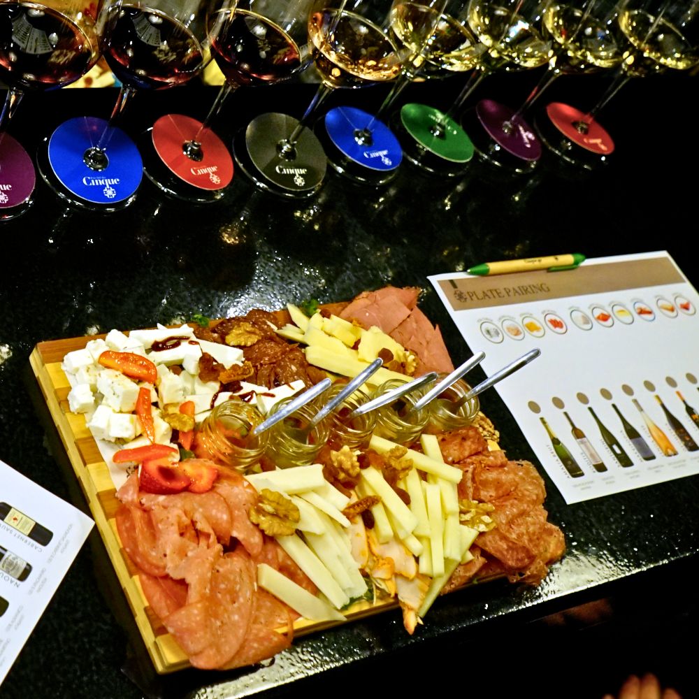 Greek wine and food pairing with charcuterie, cheeses and multiple wine glasses served at Cinque Wine & Deli