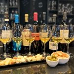 Emblematic Greek wine tasting with seven wine glasses, Greek cheeses and olives at Cinque Wine & Deli