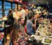 Private food and wine experience with a large group seated at a long table at Cinque