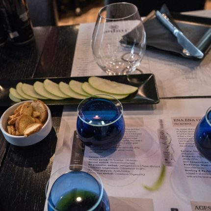 Greek olive oil and food pairing tasting with professional blue glasses, bread and fresh ingredients at Cinque Wine & Deli Athens.