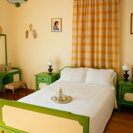 Vintage bedroom in the Malagouzia Suite at Casa Cinque in Lamia with green furniture and traditional Greek decor