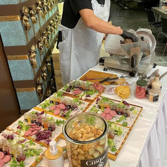 Live Greek deli and charcuterie setup with sliced meats, curated boards and artisanal accompaniments during an on-site tasting experience by Cinque Wine & Deli.