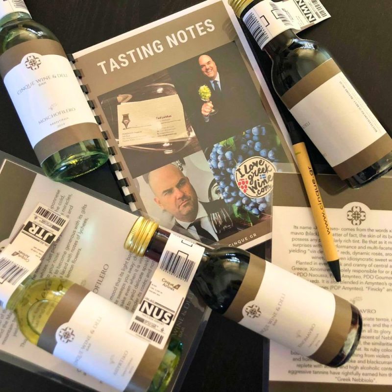 Cinque virtual wine tasting kit with small-format wine bottles, tasting notes and branded materials prepared for an online wine experience.