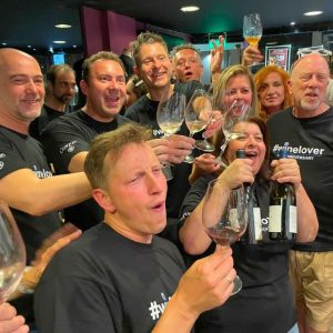Team-bonding wine experience at Cinque Wine & Deli with a group raising glasses and celebrating together