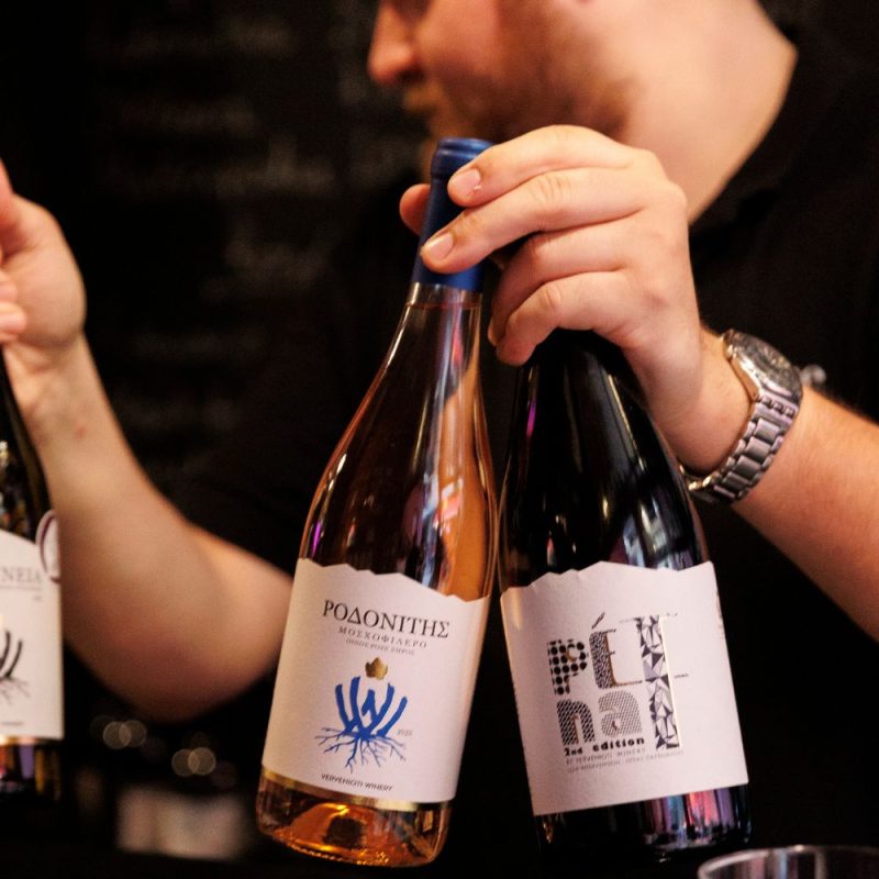 Winemaker presenting and pouring Greek wines during a Meet the Winemaker experience at Cinque Wine & Deli, highlighting human interaction and storytelling.