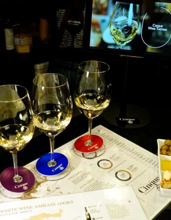 Private Greek wine tasting experience with three glasses of Greek white wine at Cinque Wine & Deli Network in Athens