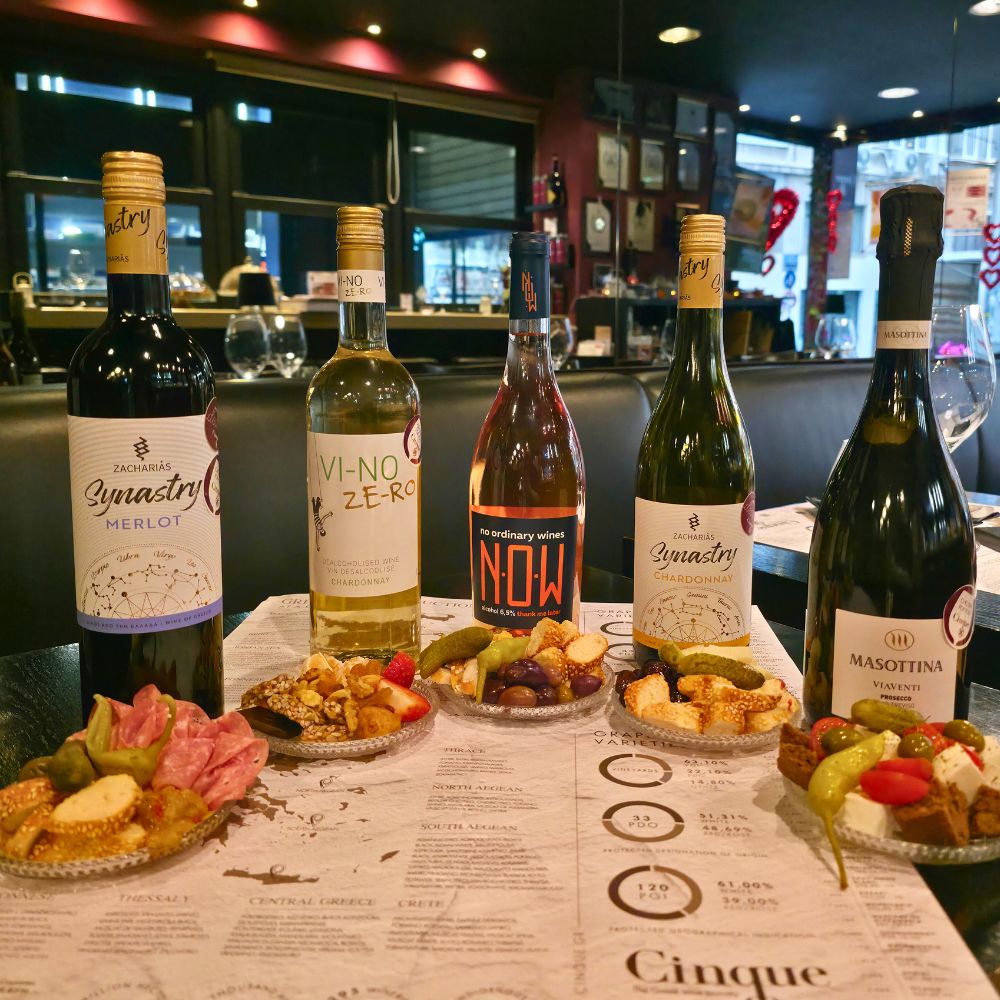 Selection of wines by the glass with Greek aperitivo plates at Cinque Wine & Deli in Athens, part of the Aperivino Social experience served from 15:00 to 19:00.