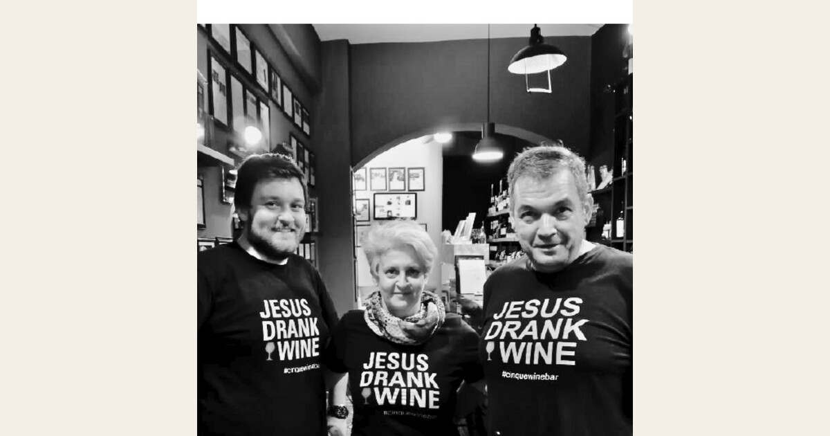 Cinque Wine & Deli team members wearing “Jesus Drank Wine” shirts inside the Athens wine bar.