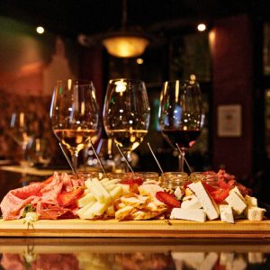Greek wine tasting flight with red and white wines paired with cheeses and charcuterie at Cinque Wine & Deli Athens.
