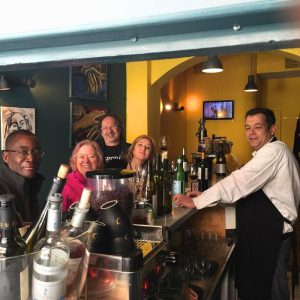 International wine lovers with Cinque team at wine bar in Psyrri Athens enjoying Greek bottled wines.