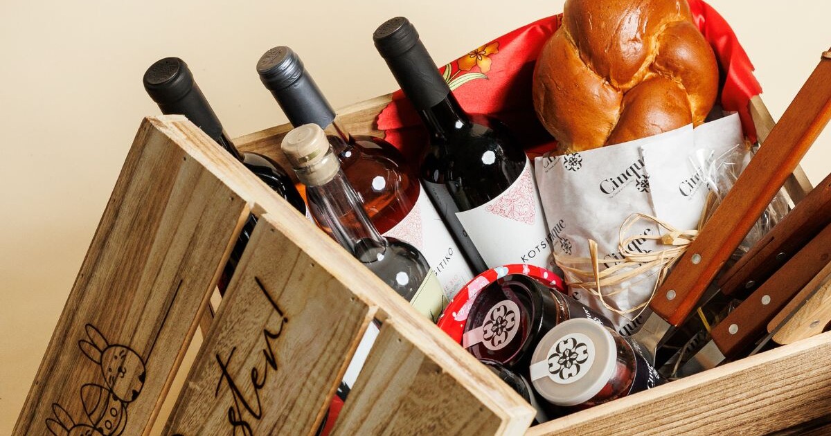 Greek Easter basket with wine bottles, tsoureki, deli products and spirits by Cinque Wine & Deli