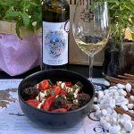 Greek salad with Cretan cherry tomatoes, feta cheese and carob rusk paired with white Greek wine at Cinque Athens.
