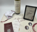 Cinque Celebrations setup with Greek wine, personalised celebration bottle, Wine Quest cards, pins and keepsake frame at Cinque Monastiraki