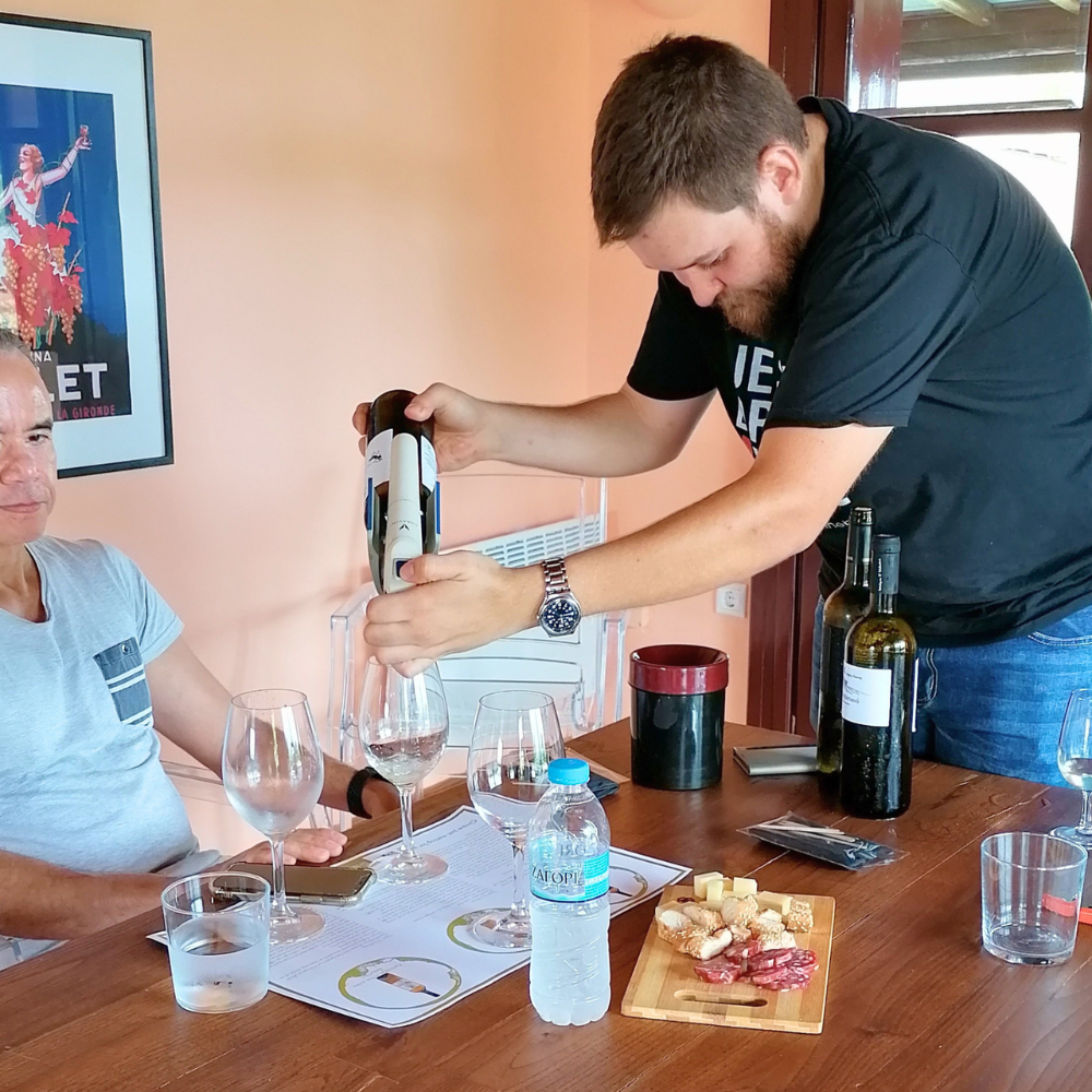 Nikitas Prassas pouring wine during a private Cinque winery tasting