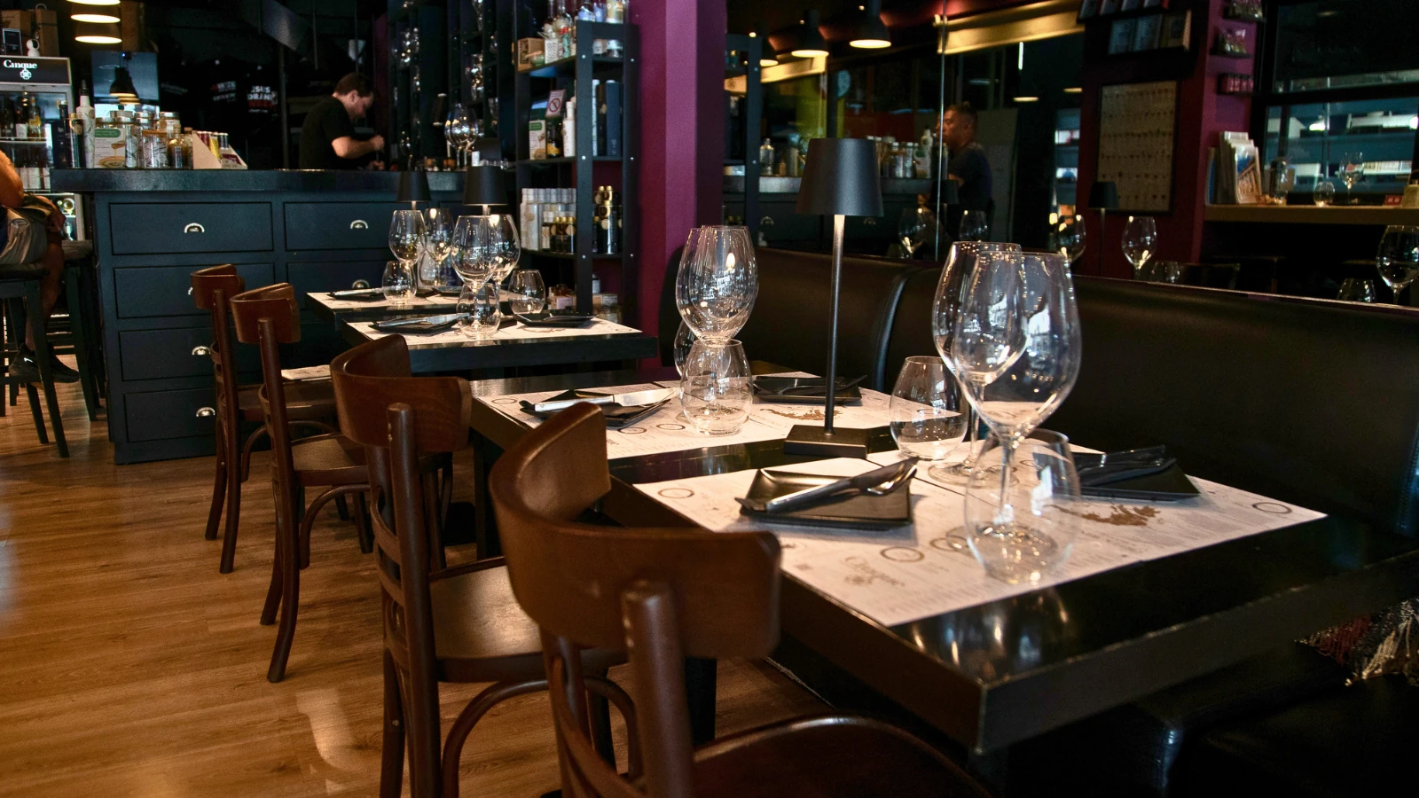 Wine glasses and tasting placemats on tables inside Cinque Wine Bar Monastiraki, Athens